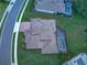 Aerial shot showcasing a house with a screened-in pool and a brick paved driveway at 16768 Sanctuary Dr, Winter Garden, FL 34787