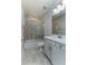 Updated bathroom features a shower over tub, white vanity, and ceramic tile floors at 16768 Sanctuary Dr, Winter Garden, FL 34787