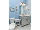 Powder bathroom with marble counter vanity, framed decor, and tiled floors at 16768 Sanctuary Dr, Winter Garden, FL 34787