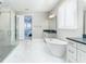 A modern bathroom with a walk-in shower and a separate tub with great lighting at 16768 Sanctuary Dr, Winter Garden, FL 34787