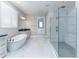 Luxurious bathroom featuring a glass shower, a freestanding tub, and elegant tile flooring at 16768 Sanctuary Dr, Winter Garden, FL 34787