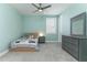 Cozy bedroom with a ceiling fan, carpet flooring, a single bed, and a gray dresser and mirror at 16768 Sanctuary Dr, Winter Garden, FL 34787