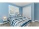 Comfortable bedroom with blue walls, ceiling fan and a window with plantation shutters at 16768 Sanctuary Dr, Winter Garden, FL 34787