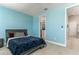 Comfortable bedroom boasts plush carpeting, a ceiling fan, and an entrance to a walk-in closet at 16768 Sanctuary Dr, Winter Garden, FL 34787