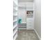Walk-in closet offering adjustable shelving and storage drawers for optimal organization at 16768 Sanctuary Dr, Winter Garden, FL 34787