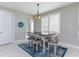 A dining area features a table with seating for six, with light streaming through the plantation shutters at 16768 Sanctuary Dr, Winter Garden, FL 34787