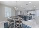 A dining area features a table with seating for six, with views of the open living room and kitchen at 16768 Sanctuary Dr, Winter Garden, FL 34787
