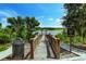 A long wooden dock on a lake leads to a covered seating area at the end of the dock at 16768 Sanctuary Dr, Winter Garden, FL 34787