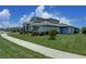 Exterior of a well-manicured lawn showcasing the side of a light blue home at 16768 Sanctuary Dr, Winter Garden, FL 34787