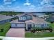 Stunning two-story home with a three-car garage, beautiful landscaping, and a view of the lake at 16768 Sanctuary Dr, Winter Garden, FL 34787