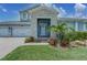 Beautiful front entrance with stone accents and lush landscaping leading to the front door at 16768 Sanctuary Dr, Winter Garden, FL 34787