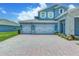 Driveway view showcasing a three-car garage of a beautiful home at 16768 Sanctuary Dr, Winter Garden, FL 34787
