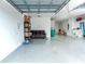 Spacious garage with epoxy flooring, overhead storage, and room for a vehicle at 16768 Sanctuary Dr, Winter Garden, FL 34787
