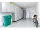 Garage with epoxy flooring, built in cabinets, and a large refrigerator at 16768 Sanctuary Dr, Winter Garden, FL 34787