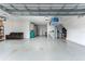 Spacious garage with epoxy flooring, storage, and room for a vehicle at 16768 Sanctuary Dr, Winter Garden, FL 34787
