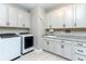 Well lit laundry room with cabinets above the sink and folding station at 16768 Sanctuary Dr, Winter Garden, FL 34787