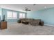 Comfortable living room features neutral walls, plush carpeting, and a large sectional sofa at 16768 Sanctuary Dr, Winter Garden, FL 34787