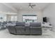 Open-concept living room with lake views beyond the sliding glass doors and a view to the dining area at 16768 Sanctuary Dr, Winter Garden, FL 34787