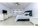 Spacious main bedroom featuring a blue bed, a ceiling fan, and natural lighting at 16768 Sanctuary Dr, Winter Garden, FL 34787