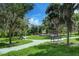 Community playground featuring benches, lush trees, and winding pathways for Gathering enjoyment at 16768 Sanctuary Dr, Winter Garden, FL 34787