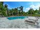 Large community pool with several lounge chairs and palm trees, perfect for relaxation at 16768 Sanctuary Dr, Winter Garden, FL 34787