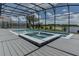Sparkling pool with a sun shelf, fountains, and a screened-in enclosure at 16768 Sanctuary Dr, Winter Garden, FL 34787