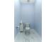 Light blue powder room offers a pedestal sink and marble-look floors at 16768 Sanctuary Dr, Winter Garden, FL 34787