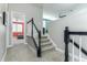 Carpeted stairway with decorative dark wood and white banister leading to the home's second level at 16768 Sanctuary Dr, Winter Garden, FL 34787