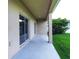 Covered back porch with sliding glass doors, offering outdoor living and access to the backyard at 1748 Thetford Cir, Orlando, FL 32824