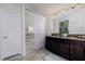 Bathroom featuring double sinks, wood cabinets, and a separate shower and tub at 1748 Thetford Cir, Orlando, FL 32824