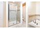 Modern bathroom with glass shower, soaking tub, and neutral tile at 1748 Thetford Cir, Orlando, FL 32824