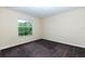 Bedroom showcasing a large window providing natural light and carpet floors ready to be transformed at 1748 Thetford Cir, Orlando, FL 32824