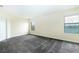 Comfortable carpeted bedroom with large windows showcasing a serene lake view at 1748 Thetford Cir, Orlando, FL 32824