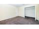 Cozy bedroom with plush carpeting and a closet offering ample storage space, ready for personalization at 1748 Thetford Cir, Orlando, FL 32824