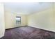 Comfortable bedroom showcasing large window offering natural light and scenic outside view, over carpeted floor at 1748 Thetford Cir, Orlando, FL 32824
