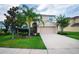 Charming two-story home with landscaped yard, a two-car garage, and a welcoming front entrance at 1748 Thetford Cir, Orlando, FL 32824