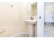 Cozy half bathroom with a pedestal sink and tile floors at 1748 Thetford Cir, Orlando, FL 32824