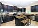 Modern kitchen featuring dark wood cabinets, stainless steel appliances, and an island at 1748 Thetford Cir, Orlando, FL 32824