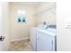 Bright laundry room with washer, dryer, and convenient shelving at 1748 Thetford Cir, Orlando, FL 32824