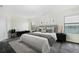 Bright main bedroom with large windows, a view of the lake, and modern decor at 1748 Thetford Cir, Orlando, FL 32824