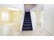 Staircase featuring tile flooring and carpeted steps, seamlessly connecting different levels of the home at 1748 Thetford Cir, Orlando, FL 32824