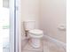 Well-maintained toilet in a bathroom with tile flooring and neutral wall color at 1748 Thetford Cir, Orlando, FL 32824