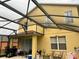 Covered backyard featuring a patio area, grill, and view of the home's exterior at 17614 Woodcrest Way, Clermont, FL 34714