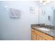 Powder room featuring a vanity and decorative wall art at 17614 Woodcrest Way, Clermont, FL 34714