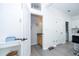 Hallway view of bathroom, desk, and access to the laundry room at 17614 Woodcrest Way, Clermont, FL 34714