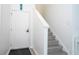 Welcoming entryway featuring light gray floors, a front door, and staircase at 17614 Woodcrest Way, Clermont, FL 34714