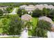 Charming yellow two-story home with well-manicured lawn and mature trees at 17614 Woodcrest Way, Clermont, FL 34714