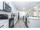 Modern kitchen featuring stainless steel appliances, white cabinetry, and plenty of counter space at 17614 Woodcrest Way, Clermont, FL 34714