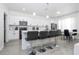 Bright kitchen features stainless steel appliances, an island with bar stool seating, and lots of natural light at 17614 Woodcrest Way, Clermont, FL 34714