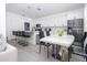 Bright kitchen with white cabinets, stainless steel appliances, and island with seating at 17614 Woodcrest Way, Clermont, FL 34714